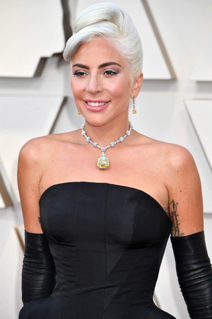 Lady Gaga wearing a diamond choker with a black tube-topped dress.