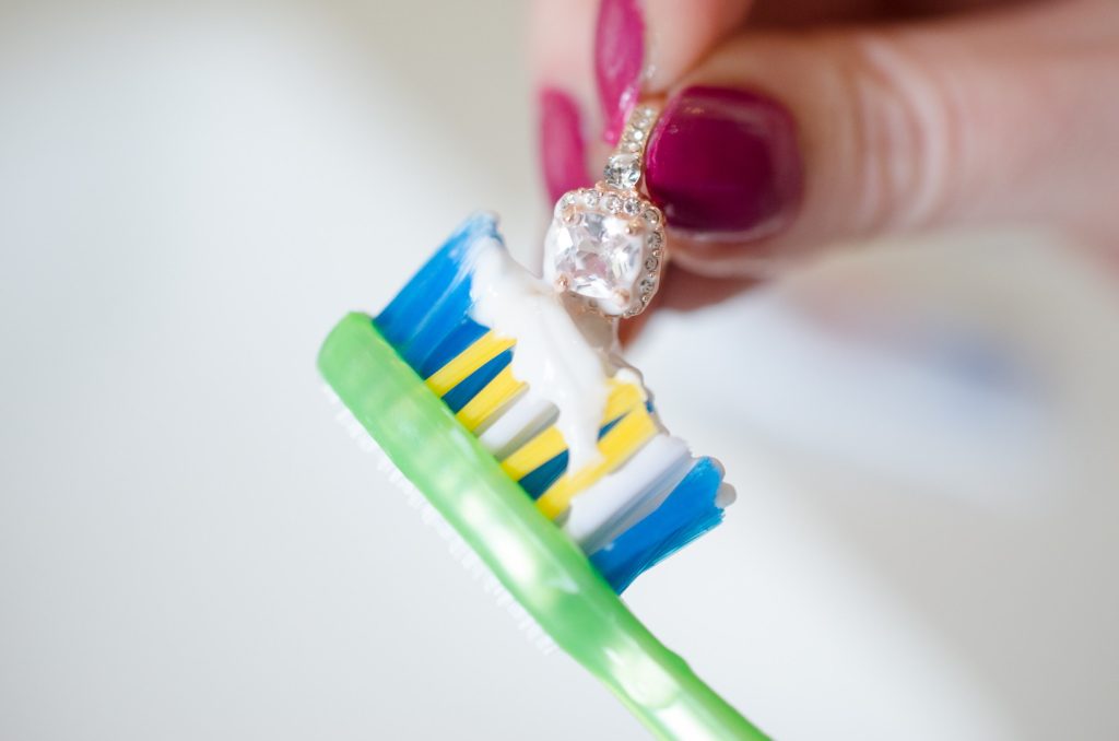 Brushing clarity-enhanced diamonds  set on a gold ring