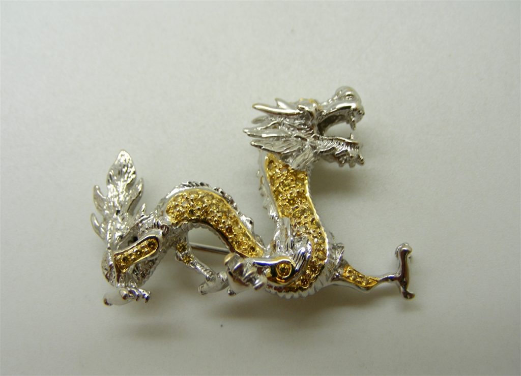 Diamonds on a gold and silver dragon pin