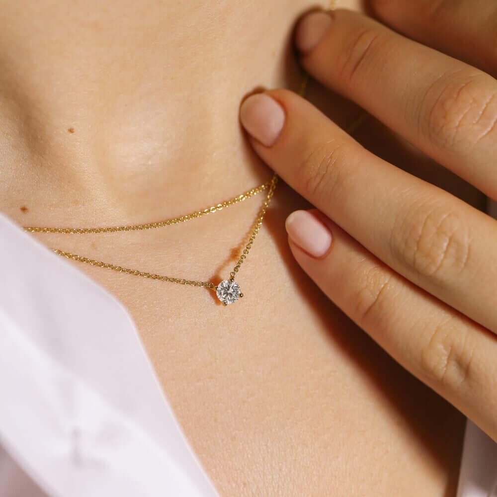 Dainty diamond pendant set on a thin, gold chain