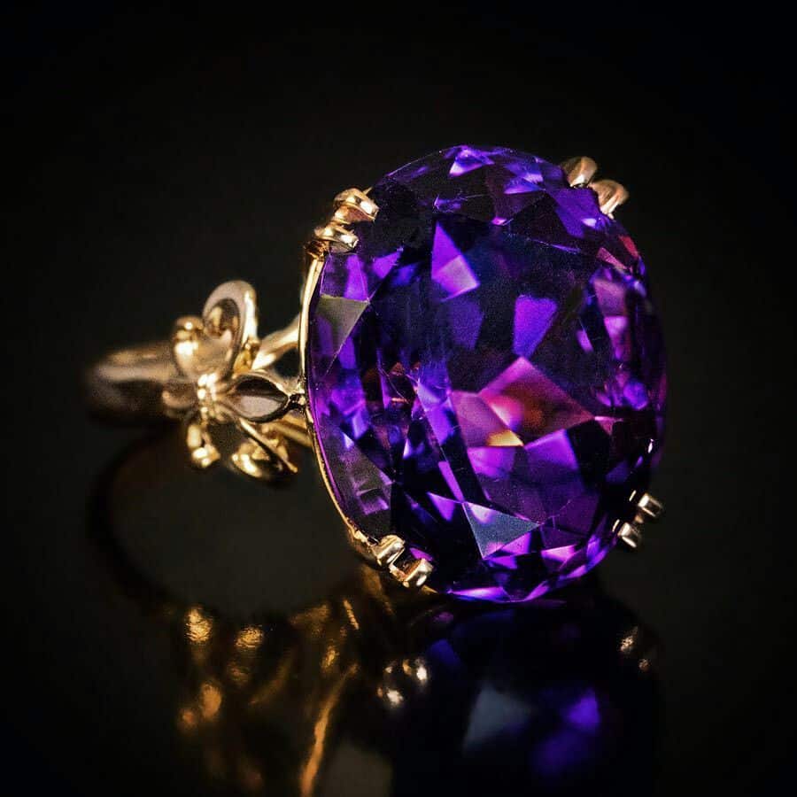 Plum diamond set in a gold ring