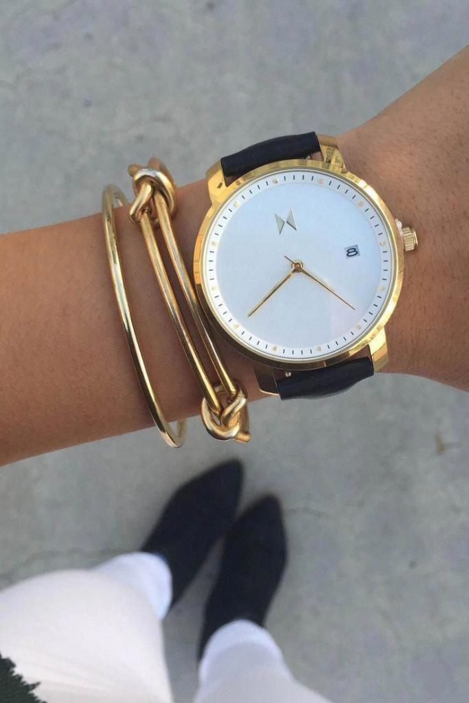 A watch highlighted by a couple of simple gold bangles